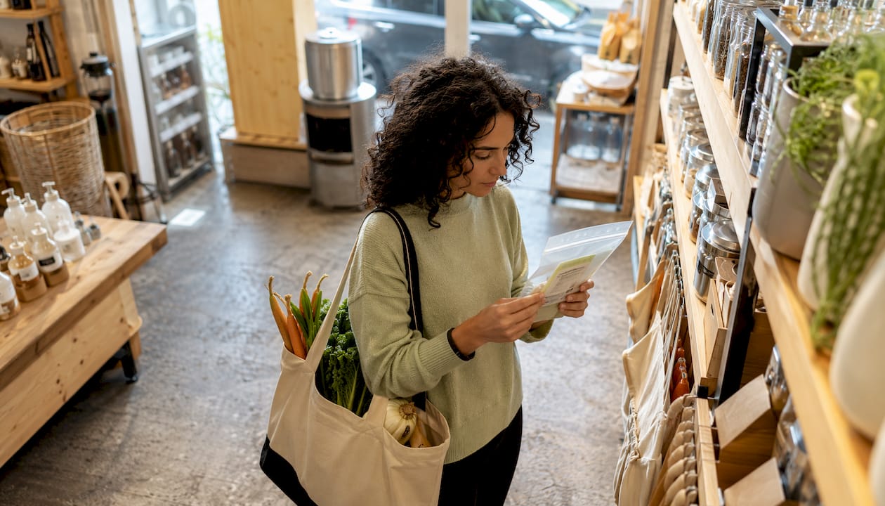 Shopper examining PLA food bag in store aisle