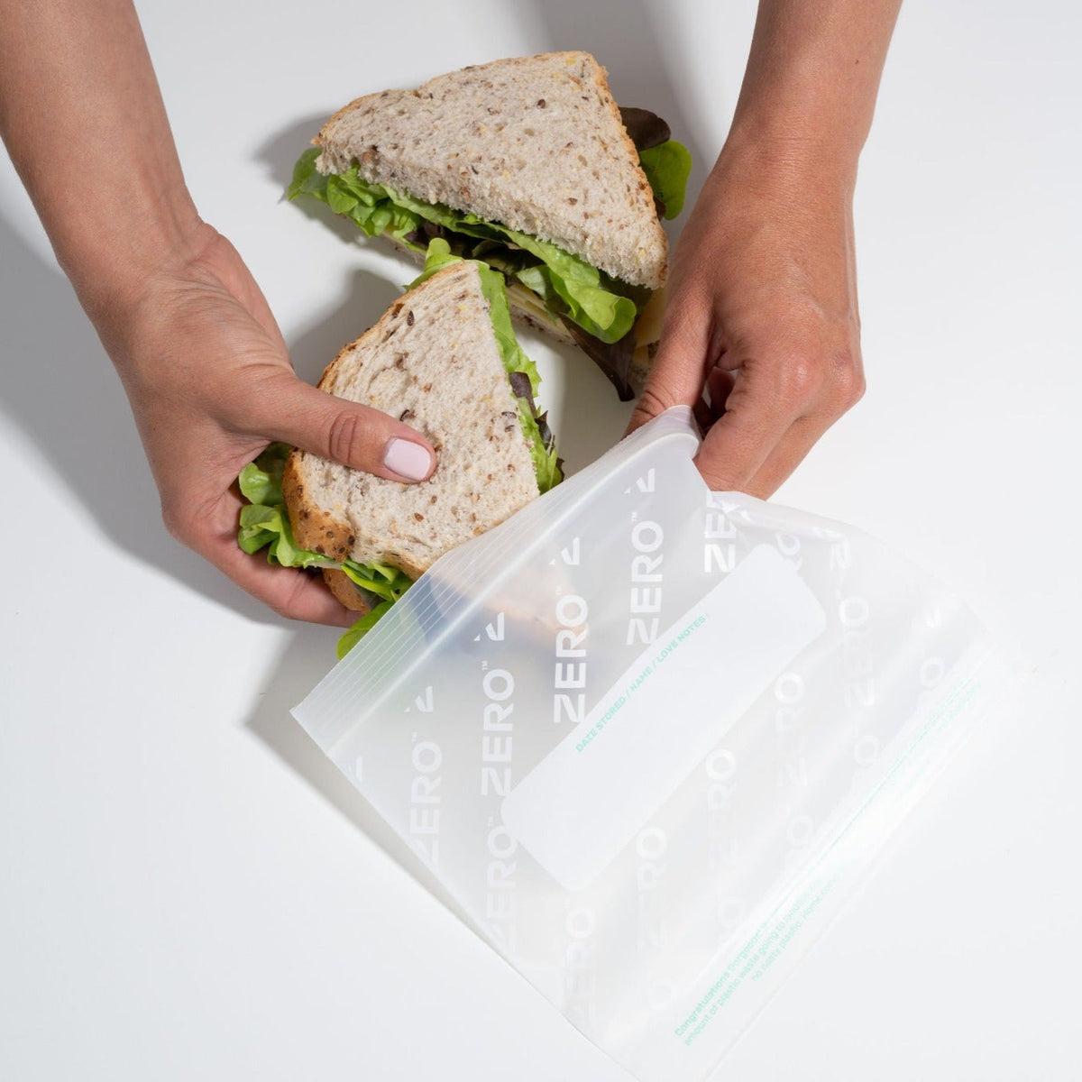 ZERO resealable storage bag holding a sandwich